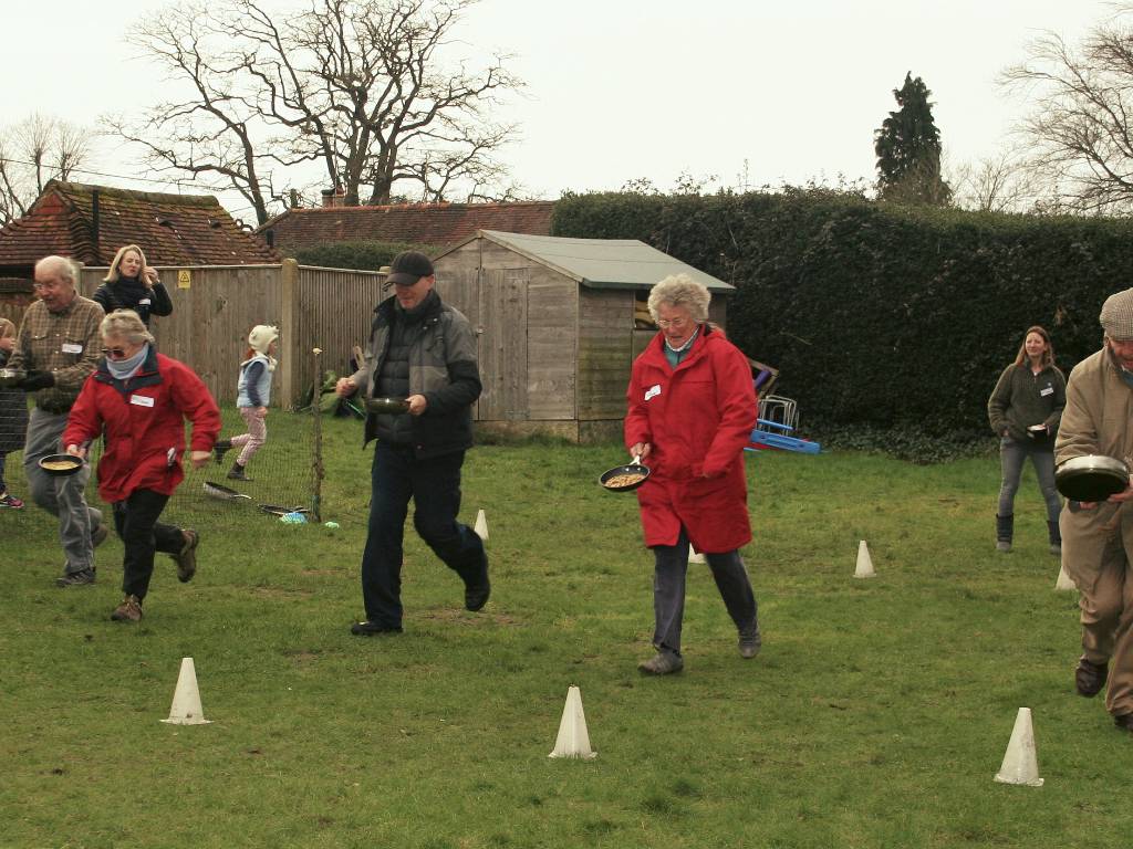 Pancake race at Thursley Village Hall 
